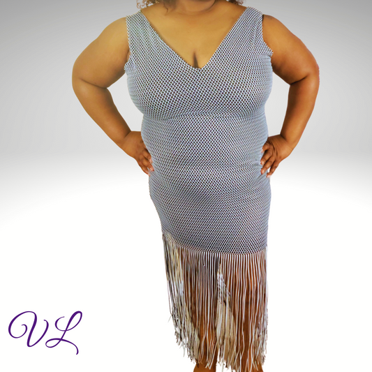 The Ashlyn Dress is a black and white woven sleeveless dress.  The dress has a back zipper with a v-neckline on both sides.  Made of 90% polyester and 10% spandex this dress has plenty of stretch plus it comes with 100% polyester liner. The Ashlyn has a fringe bottom that will give you plenty of movement when you walk.  Perfect addition to add to your woredrobe.