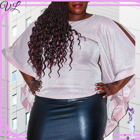 The Alessandra top has 3/4 length sleeves that flows with every move.  Colored in a blush pink with shiny metallic the top is ready to shimer.  There is also a cold shoulder cut to show just enough skin.  Made in the U.S.A. of 65% nylon and 35% metallic.  The Alessandra top has all the extra drama you need to stand out from everyone for the night.  This top runs true to size.