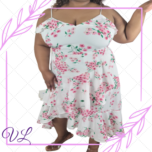 The Alondra Maxi dress is a white and pink floral adjustable spaghetti strap dress.  It has a single ruffles across the top and double ruffles at the bottom of the dress just below the hips.  Made of 100% polyester the material is light and airy.   The Alondra has a hidden zipper in the back and also a slight split on one side  just above the knee, which helps give plenty of  movement when you walk.  The Alondra will be the perfect dress for the moments when you just want to be feminine.